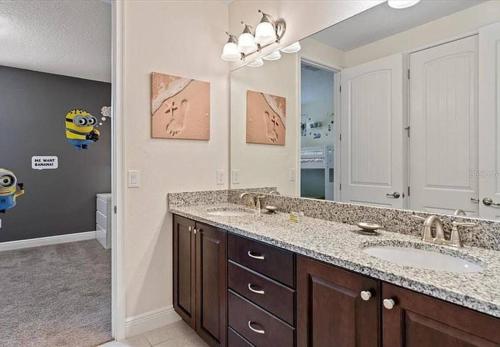 a bathroom with two sinks and a large mirror at 371 P Luxury Villa- New Listing in Orlando