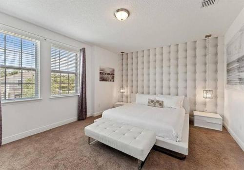 a white bedroom with a large bed and windows at 371 P Luxury Villa- New Listing in Orlando