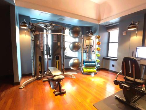a fitness room with a gym with exercise equipment at The Ned NoMad in New York