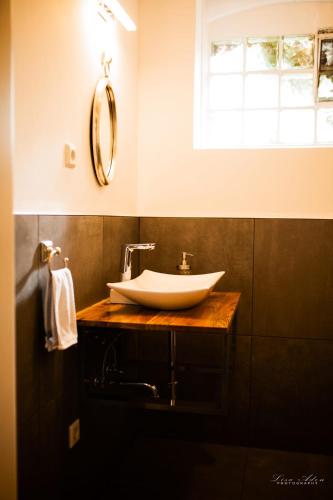 a bathroom with a white sink and a window at Snow White in Kürten