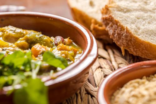 a bowl of food with bread and a bowl of soup at Hotel Rural El Refugio in Tejeda