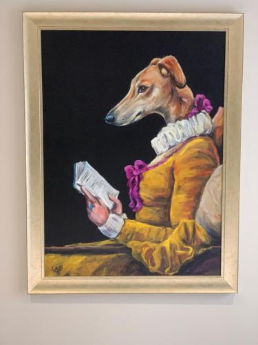 una pintura de un perro sosteniendo un libro en The Pig and Whistle, en Londres