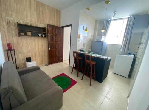 a living room with a couch and a kitchen at 1/4, sala, Farol da Barra. in Salvador