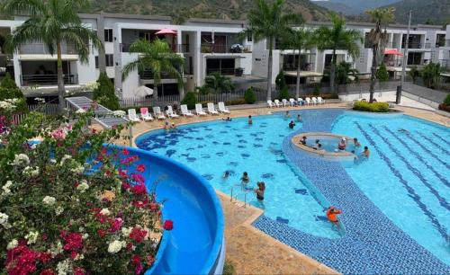 a pool at a hotel with people in it at Apartamento vista piscina principal in Santa Fe de Antioquia