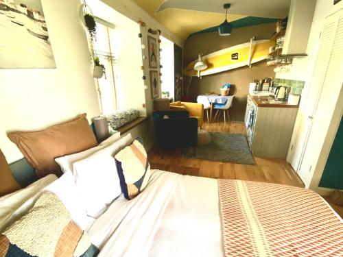 a bedroom with a bed and a kitchen in a room at St Ives Balcony Flat in St Ives