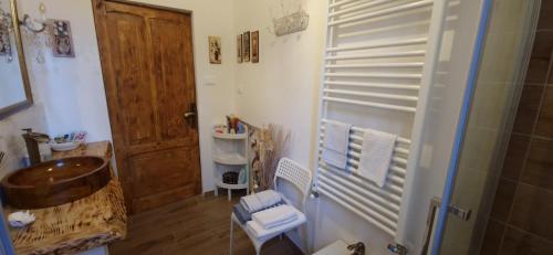 a bathroom with a sink and a wooden door at Bologna Minimal Chic House Relax Parking Nature Near Center in Bologna