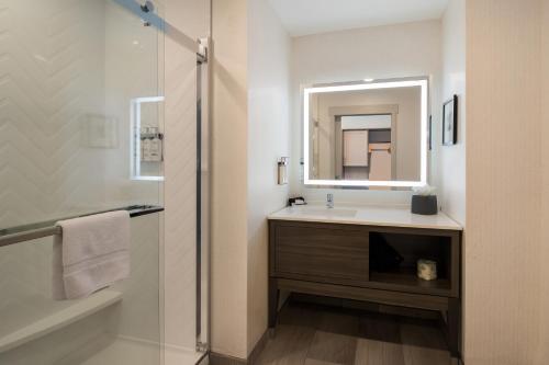 a bathroom with a sink and a mirror at Holiday Inn & Suites - Mt Juliet Nashville Area, an IHG Hotel in Mount Juliet