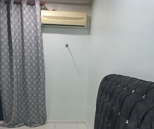 a room with a air conditioner and a curtain at RVH Kuala Terengganu in Kuala Terengganu