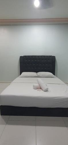 a bed with two white towels on top of it at RVH Kuala Terengganu in Kuala Terengganu