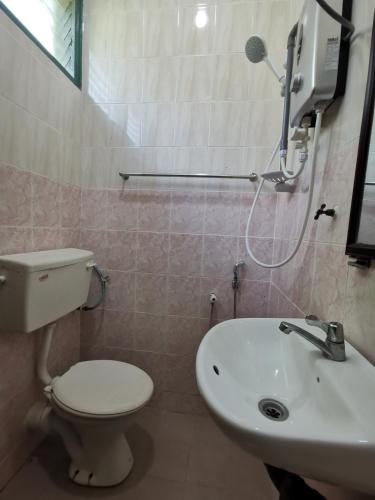 a bathroom with a toilet and a sink at RVH Kuala Terengganu in Kuala Terengganu
