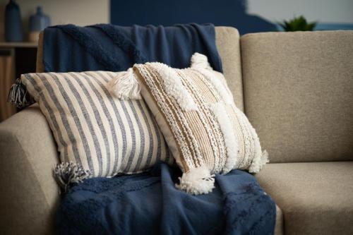 a pile of pillows sitting on a couch at UTAH Maritime, FAST WIFI, Conventions, King Bed in Salt Lake City