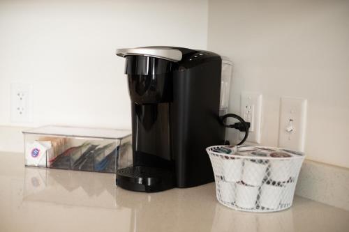 a coffee maker and a basket on a counter at UTAH Maritime, FAST WIFI, Conventions, King Bed in Salt Lake City