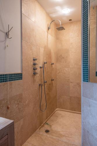 a bathroom with a shower with a glass door at Tinkers Folly in Harrogate