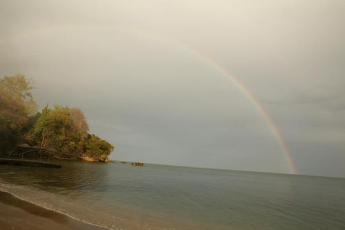 a rainbow over a body of water with trees at Sinop Antik Otel in Sinop