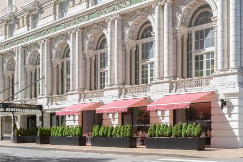 a large building with pink umbrellas in front of it at The Hermitage Hotel in Nashville