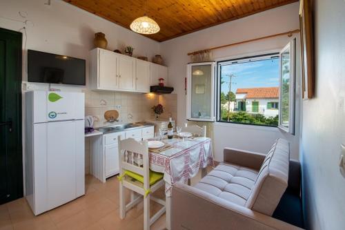 a small kitchen with a table and a kitchen with a counter at Arthur House in Longós