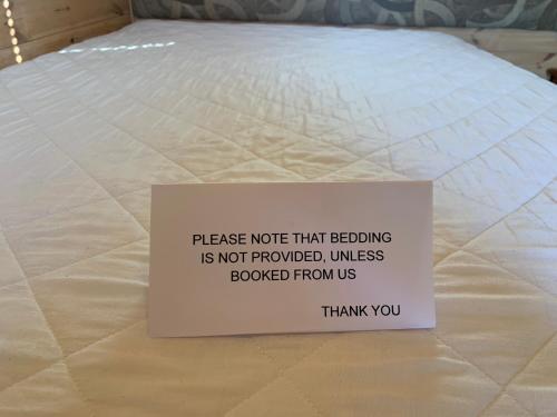 a sign sitting on top of a mattress at Poplars Farm Site Glamping Pods Adults only with separate, private shower rooms in Hulland