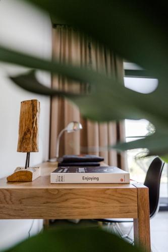 a table with a lamp and a book on it at Sommers "Schöne Aussicht", Adults only in Reichenbach im Vogtland