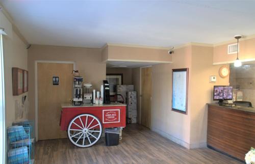 a restaurant with a red cart in a room at Eastern Shore Motel in Daphne