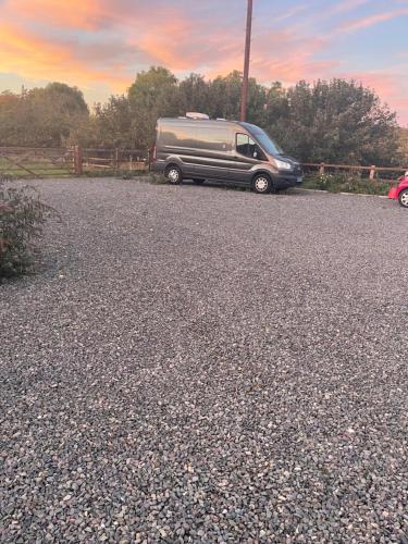 a black van parked on the side of a road at Apple Barn Guest House in Wisbech