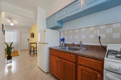 a kitchen with a white refrigerator and a sink at Miami 1 Bedroom Apt With Parking in Miami