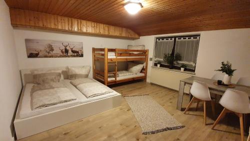a bedroom with a bed and a table and a desk at Apartment Silva in Kappel-Grafenhausen