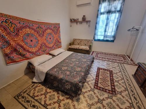 a bedroom with a bed and a rug at Shams House in Amman
