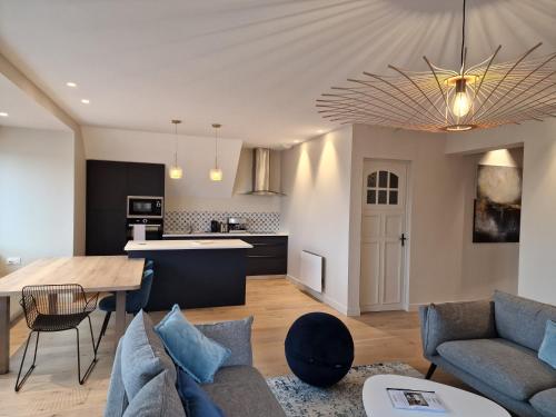 a living room with a couch and a table at La touline in Concarneau