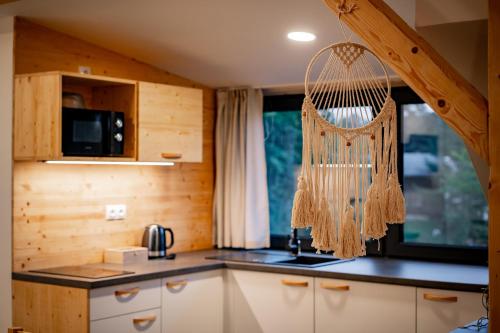 a kitchen with a net hanging from a window at Apartmány NONE in Branná