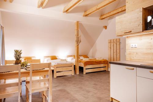 a kitchen and dining room with a table and chairs at Apartmány NONE in Branná