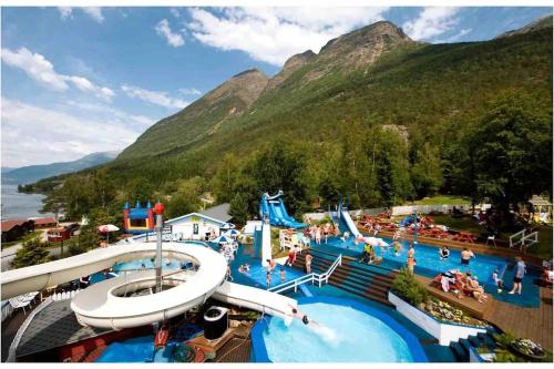 a resort with a water park with people in it at Fjellhytte på hardangervidden med uforglemmelig utsikt! in Garden