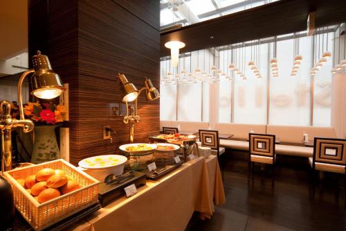a buffet line with food on a table in a room at Citadines Central Shinjuku Tokyo in Tokyo