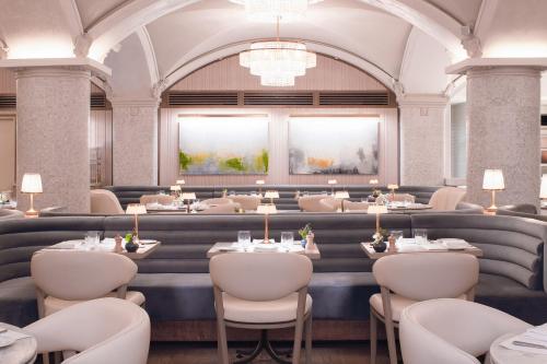 a restaurant with tables and chairs and lights at The Hermitage Hotel in Nashville
