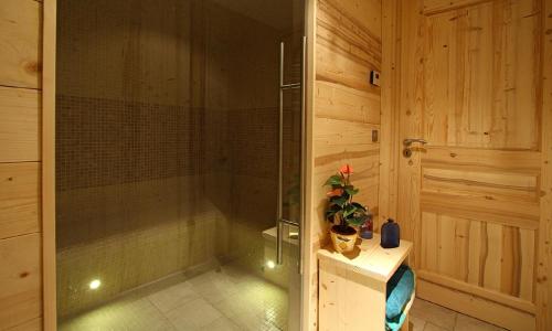 a shower with a glass door in a bathroom at Odalys Chalet Husky in Les Deux Alpes