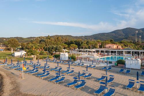 a row of chairs and a pool at a resort at Hotel Airone isola d'Elba in Portoferraio