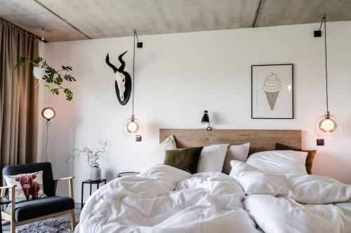 a bedroom with a large bed with white sheets at Sommers "Schöne Aussicht", Adults only in Reichenbach im Vogtland