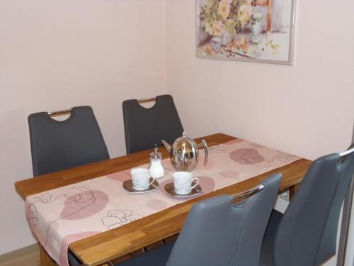 a dining room table with chairs and a table with a table cloth at Ederauenblick in Dodenau