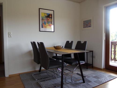 a dining room table with chairs and a bowl on it at Ederauenblick in Dodenau