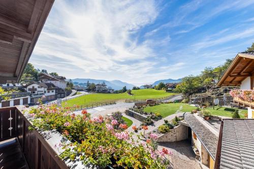a view from the balcony of a house with flowers at Florerhof Ferienwohnung Flieder in Vols am Schlern