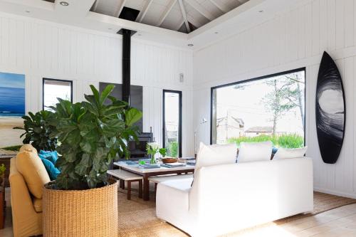 a living room with a white couch and a table at Casa Flor in Punta del Este