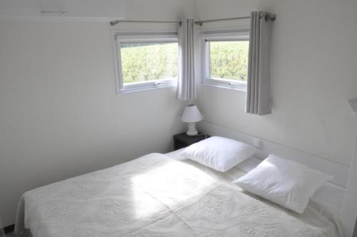 A bed or beds in a room at Les Cottages des Pierres d'Aurèle