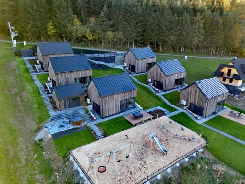 an aerial view of a house with a playground at Domki z Górki na Pazurki in Falsztyn