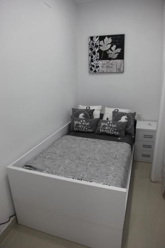 a white bed in a white room with a mattress at Apartamentos Alogia, Pastora, Yerbater in Segorbe