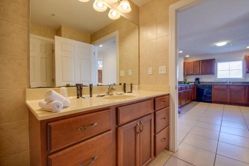 a bathroom with a sink and a large mirror at Americana Condos 10th street in Ocean City