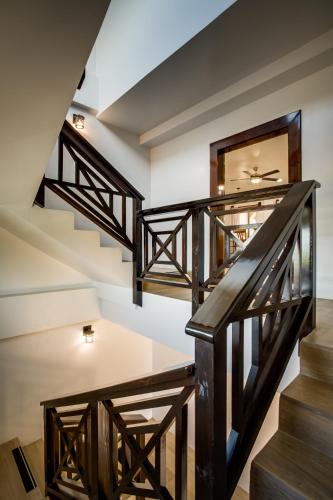 a staircase in a house with wooden railings at Marsh Madness in Maya Beach