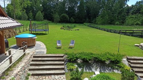 a large yard with two chairs and a playground at Dom Królewski Róg in Giżycko