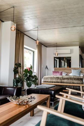 a living room with a bed and a couch at Sommers "Schöne Aussicht", Adults only in Reichenbach im Vogtland