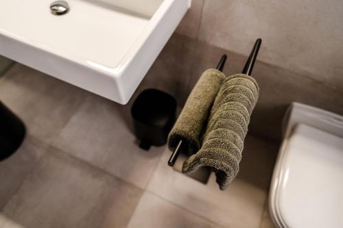 a bathroom with two towels hanging from a sink at Sommers "Schöne Aussicht", Adults only in Reichenbach im Vogtland