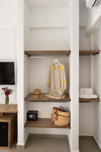 a shelf in a room with a shirt on it at Vivianna's View in Azolimnos
