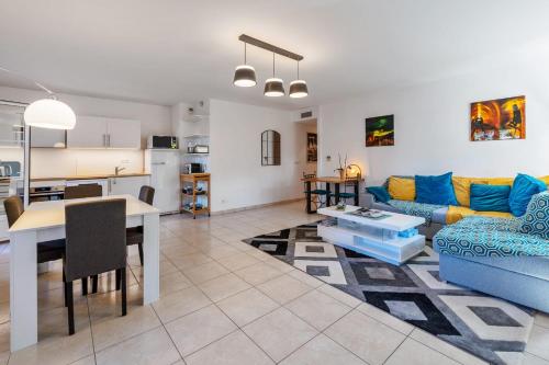 un salon avec un canapé bleu et une table dans l'établissement Appartement du Brost - Résidence le clôt des Sarments - Welkeys, à La Croix-Valmer